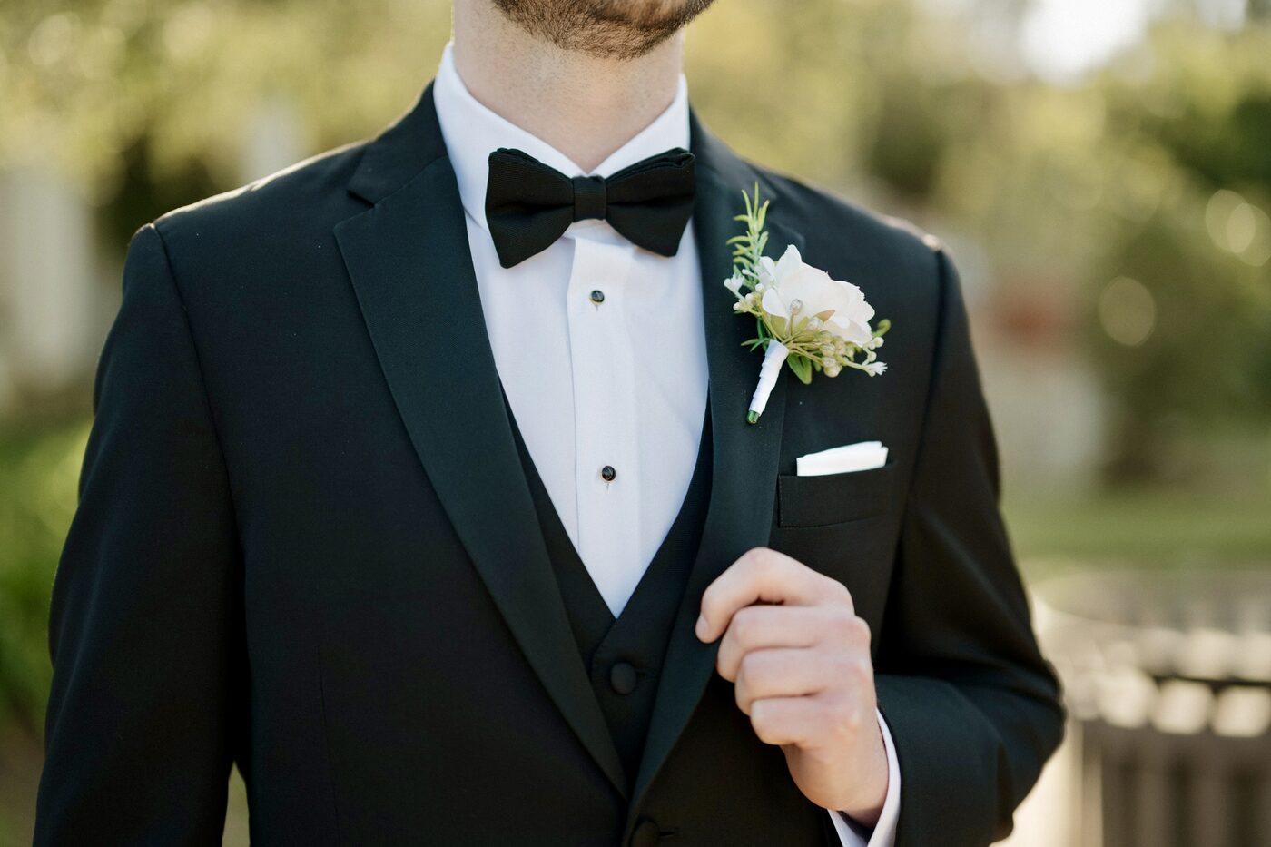 Groom's boutonniere in white and greenery