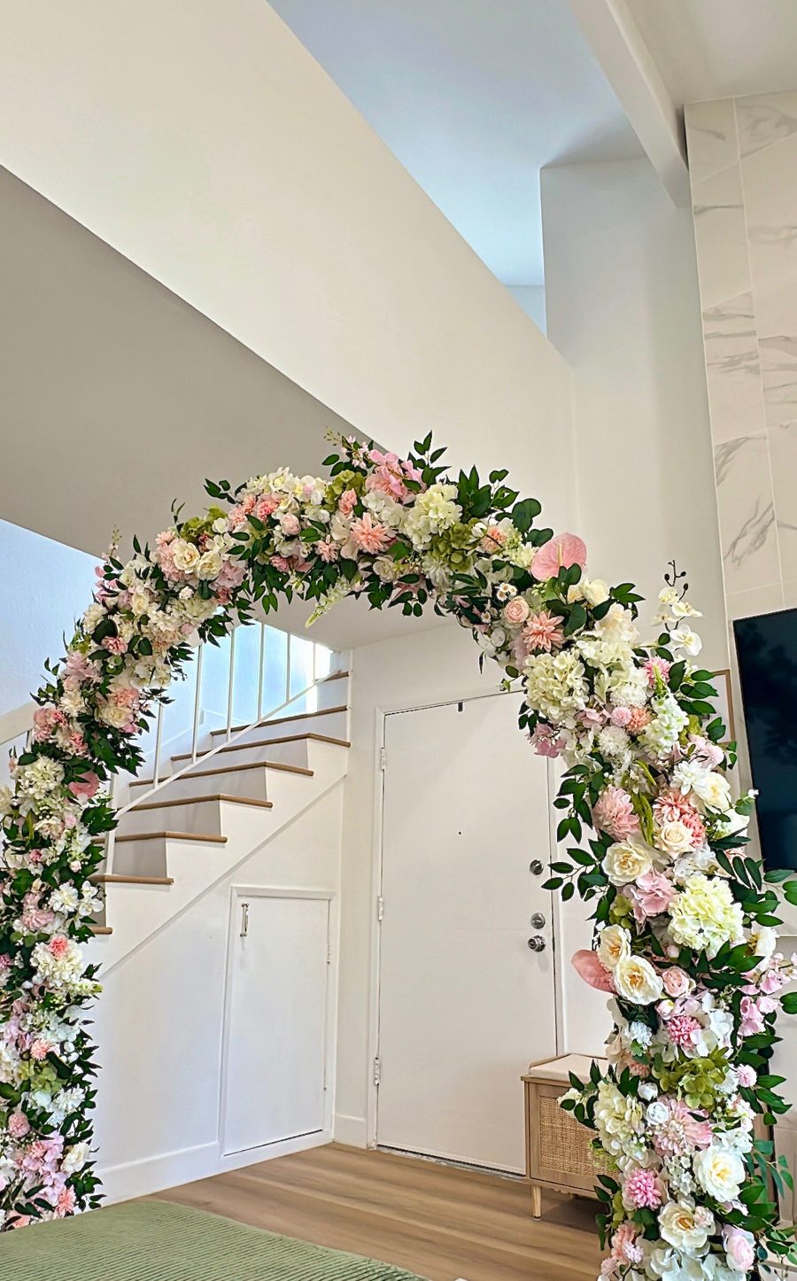 The same two large floral installations joined together and styled as an arch