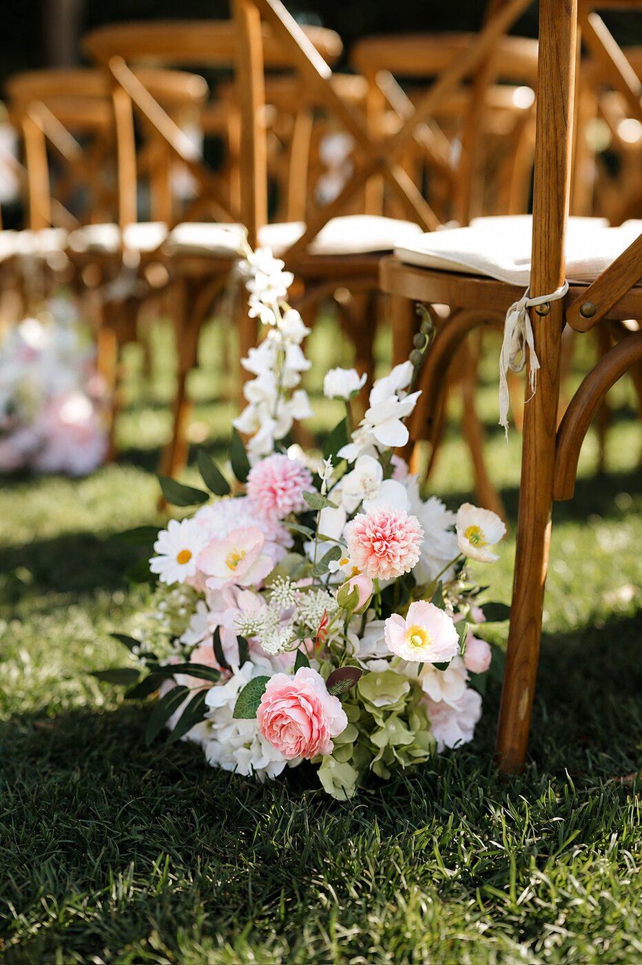 Meadow aisle floral arrangements lining the ceremony aisle